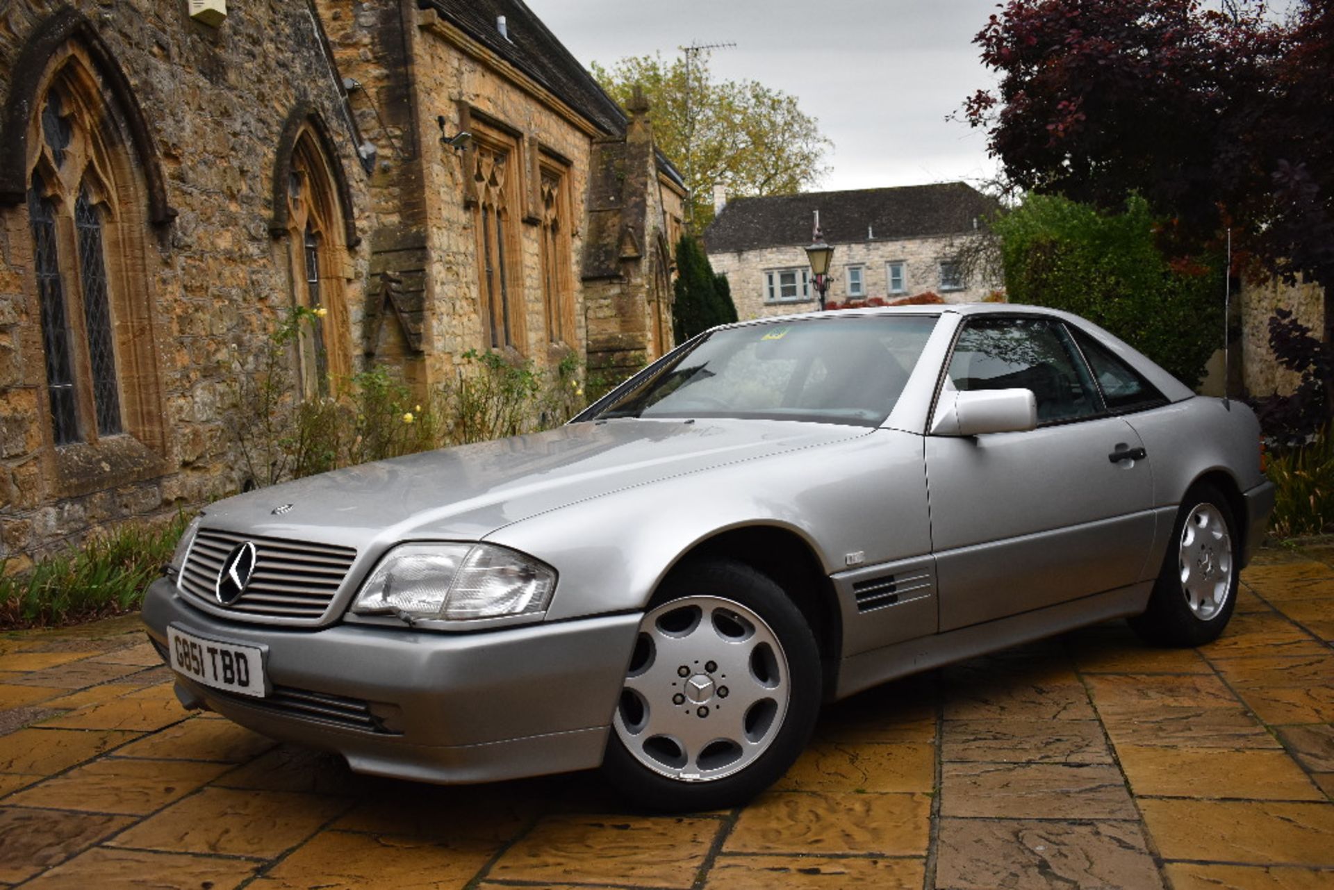 A 1990 Mercedes-Benz SL300, registration number G851 TBD, silver.