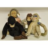 A Merrythought plush monkey pyjama case, 62 cm high, three similar monkey toys, and a plush cat,