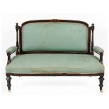 A late Victorian ebonised and amboyna parlour suite, comprising a settee,