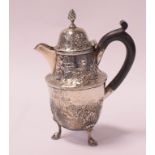 An 18th century style silver lidded jug, embossed ribbons, flowers and foliage,