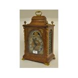 A George III style bracket clock, the 13 cm arched square brass dial signed John Taylor, London,