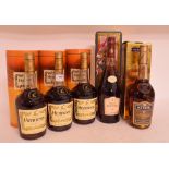Three bottles of Hennessy VS cognac, a bottle of Polignac cognac, and a bottle of Martell VS cognac,