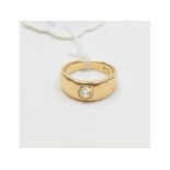 An 18ct gold band ring, set a solitaire diamond, approx. ring size L, approx. 7.