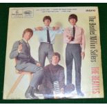 Assorted vinyl record singles, including The Beatles, Elton John and Everly Brothers,