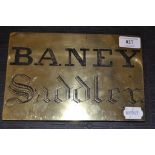 A brass door plate, inscribed BANEY Saddler,