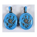 A pair of turquoise enamel lockets,