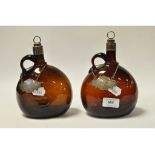 A pair of silver mounted glass flasks, each with a single loop handle,