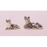 A miniature silver cat, with emerald set eyes, 2 cm high,