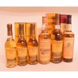 A bottle of Glenmorangie Millenium malt whisky, First Fill Cask, two other bottles of Glenmorangie,