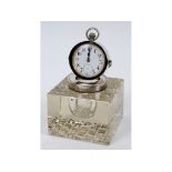 A silver mounted glass ink well, incorporating a pocket watch on an adjustable frame,