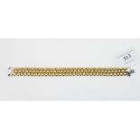 An 18ct yellow and white gold bracelet, the clasp set diamonds, approx. 32.