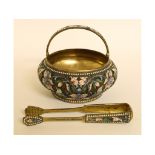 A Russian silver gilt and enamel swing handle sugar basket, decorated flowers and foliage,