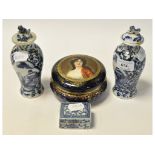 A pair of Chinese blue and white vases and covers, decorated figures, 18 cm wide,