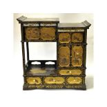 A Japanese laquered and Shibayama inlaid Tansu or table cabinet, having an arrangement of drawers,