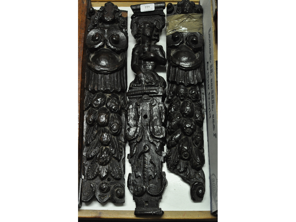 A pair of carved wood panels, decorated figures and foliage, 52 cm high, and another similar panel,
