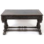 A late Victorian Anglo-Flemish oak writing table, having a leather inset top,