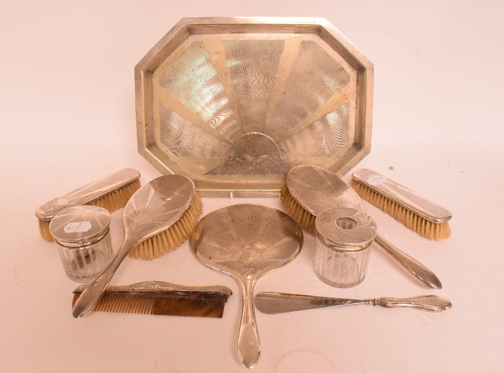 A silver mounted dressing table set, various dates and makers, a matching plated tray,