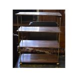 A Regency rosewood four tier etagere, on brass supports and ball feet,
