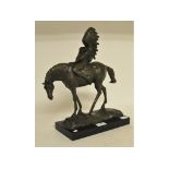 A bronzed group, in the form of an Native American on horseback, on a marble plinth,