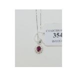 A 9ct white gold, ruby and diamond pendant,