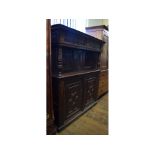 An oak court cupboard, with geometric panel doors,