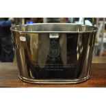 A plated champagne bucket, engraved a crest and a quote,