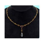 A yellow coloured metal necklace, with filigree decoration, set aquamarine, topaz,