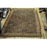 An Eastern rug, decorated geometric motifs on a dark blue ground, within a multi border,