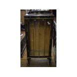 An early 20th century bow front display cabinet, with black chinoiserie style decoration,