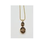 An 18ct gold and oval smoky quartz double pendant, on an 18ct gold chain, approx. 12.