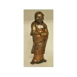 An Eastern bronze figure, in the form of Bodhidharma,