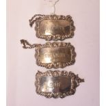A pair of silver decanter labels, SHERRY and GIN, Sheffield 1977, another similar, BRANDY,