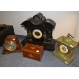 A late Victorian slate mantel clock, 49 cm wide, two other clocks, an inlaid mahogany tea caddy,