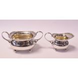 A Victorian silver two handled sugar bowl, and a matching silver cream jug, London 1900, approx. 11.