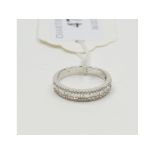 An 18ct white gold and diamond half hoop ring, set baguette and brilliant cut stones, approx.