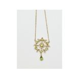 An Art Nouveau style 9ct gold, peridot and diamond pendant,