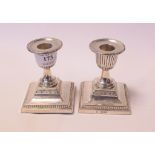 A pair of silver dwarf candlesticks, Sheffield 1904, 9 cm high, a silver tabletop cigarette box,