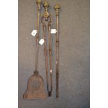 A set of three 19th century steel fire irons, with brass flowerhead handles,