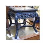 A Chinese carved and pierced hardwood jardiniere stand, with a marble inset top,