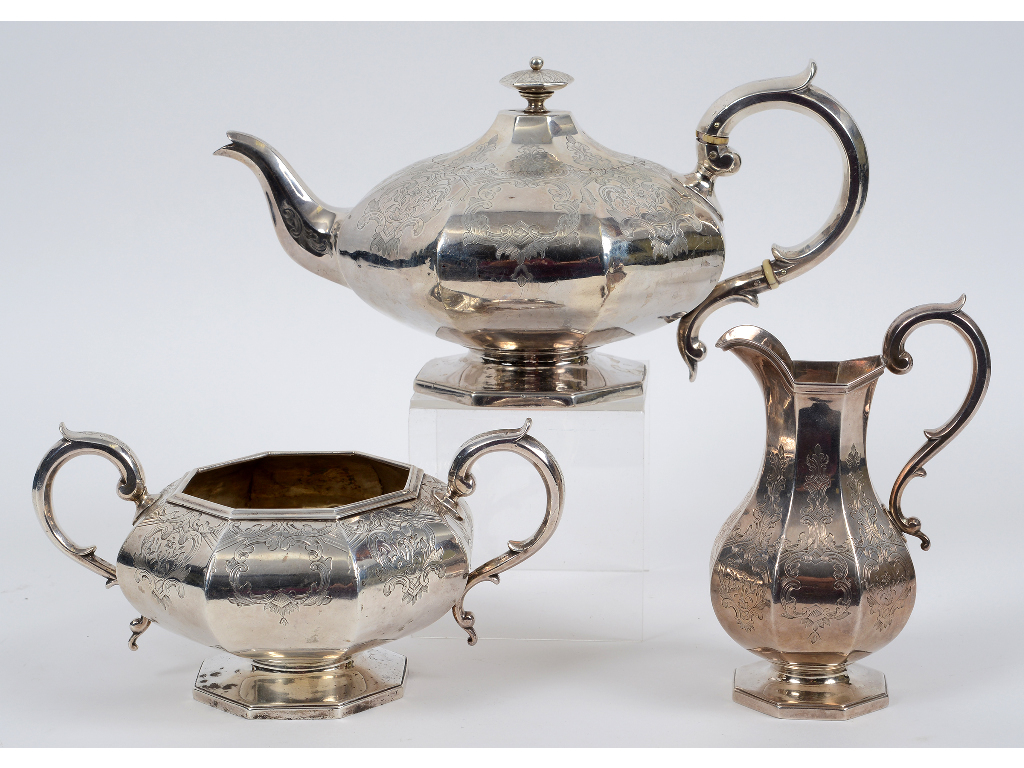 A Victorian silver three piece tea set, of compressed octagonal form, engraved fflowers and foliage,