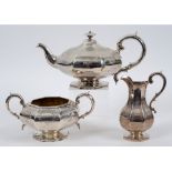 A Victorian silver three piece tea set, of compressed octagonal form, engraved fflowers and foliage,