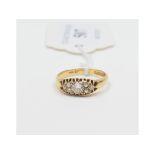 An 18ct gold and diamond ring, the larger brilliant cut stone flanked by six smaller stones, approx.