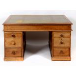 A late Victorian desk, the leather inset top above an arrangement of six drawers,