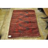 An Afghan rug, decorated four medallions on a red ground, within a multi border, 162 x 96 cm,