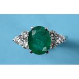 An 18ct white gold, emerald and diamond ring,