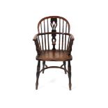 A late 19th century ash and elm hoop back kitchen arm chair,