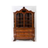 A Dutch walnut bombé cabinet on chest, inlaid with beasts, scrolling acanthus leaves,