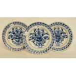 A set of three Dutch Delft plates, decorated vases of flowers, some fritting,