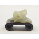 An Eastern carved jade duck, on a hardwood stand,