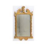 A George II style carved giltwood mirror, with an acanthus leaf finial,